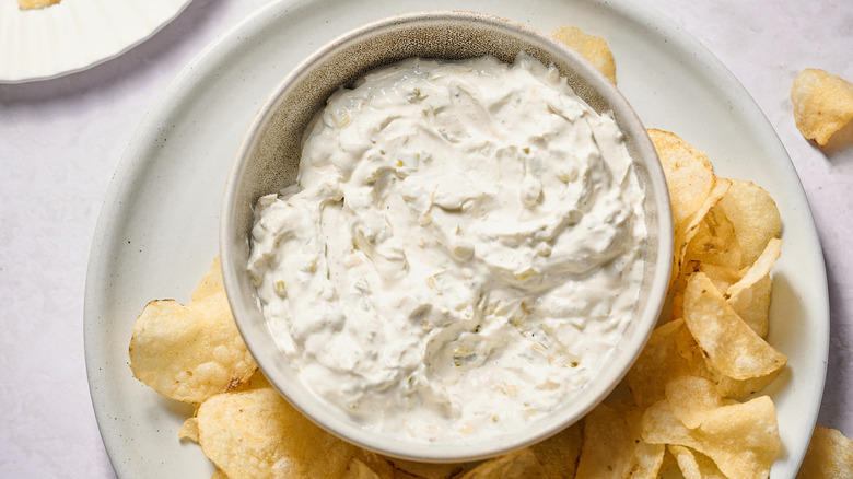 Onion dip and potato chips on plate