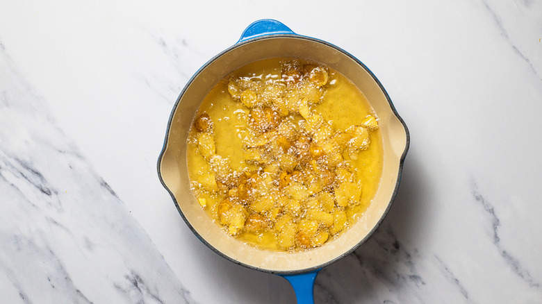 Potatoes frying in oil.