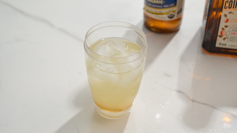 cocktail ingredients added to shaker