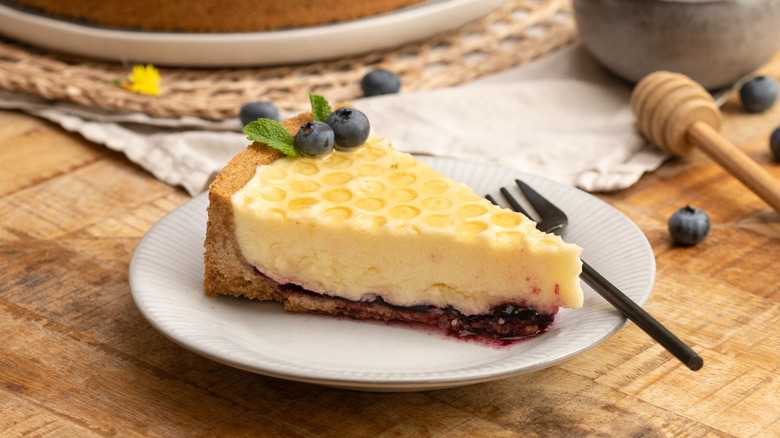 slice of blueberry elderflower honeycomb pie on small plate with fork