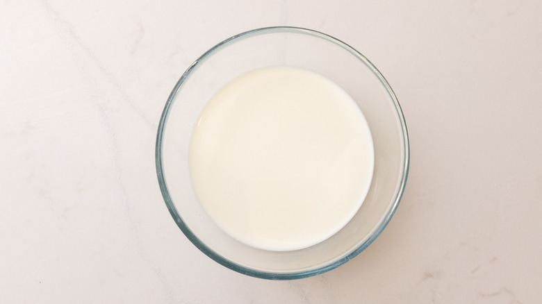 aerial view of hot milk in a bowl on marble surface