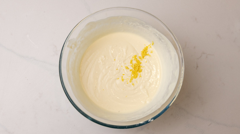 aerial view of lemon zest and custard in a glass bowl