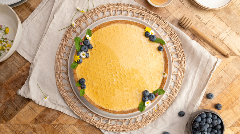 aerial view of blueberry elderflower honeycomb pie on placemat