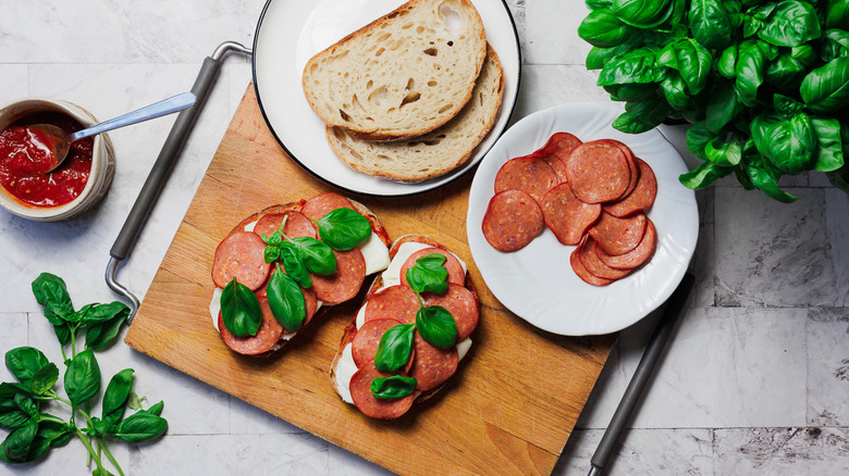 Assembling grilled cheese sandwiches on cutting board