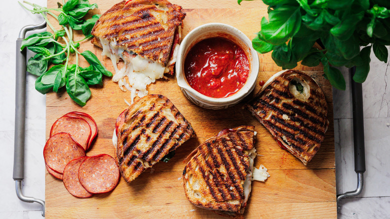 Pizza grilled cheese halves on cutting board