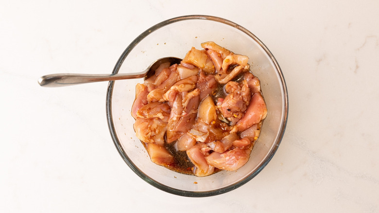 chicken marinading in a bowl