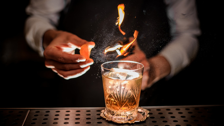 bartender making smoked old fashioned