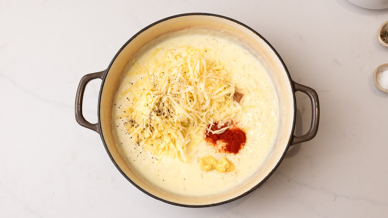 adding ingredients to creamy sauce