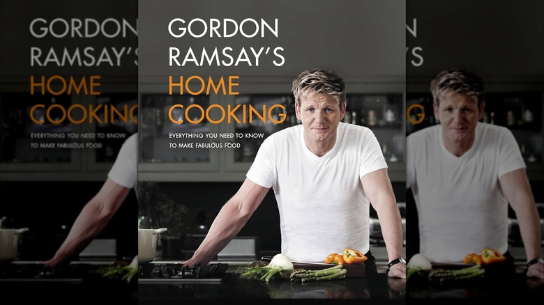 Gordon Ramsay in a white T-shirt with several ingredients in front of him on the cover of a cookbook