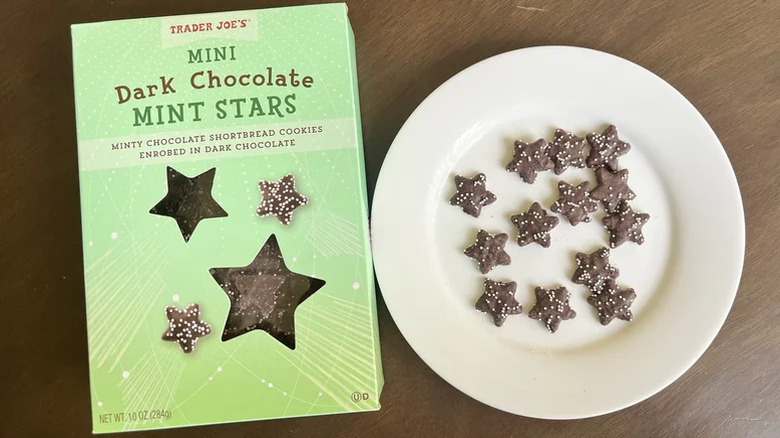 A box of Mini Dark Chocolate Mine Stars next to a plate of the cookies