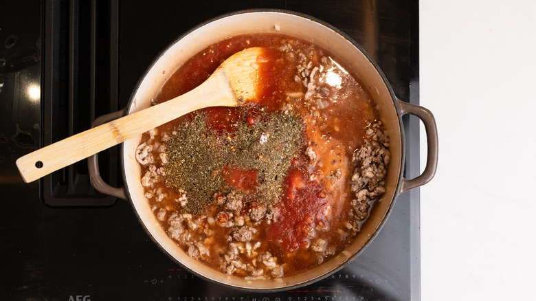 adding sauce ingredients to pan
