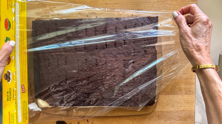 hands wrapping sandwich with wrap