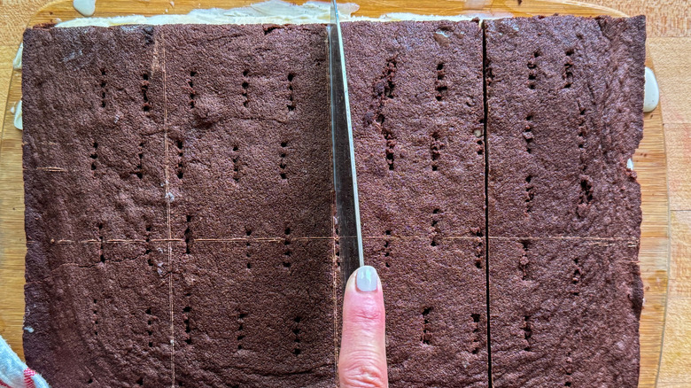 hand cutting ice cream sandwich