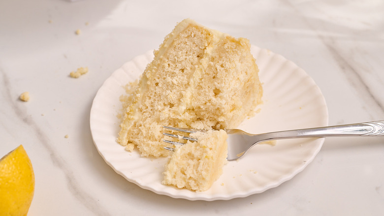 fork on a plate with lemon cream cake
