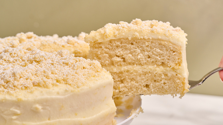 lifting slice of cake off of cake stand