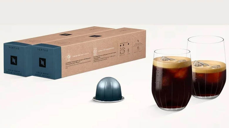Nespresso cold brew starter kit with two sleeves and two glasses of cold brew with one pod out