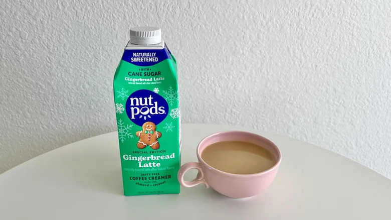 Nutpods gingerbread latte creamer with cup of coffee
