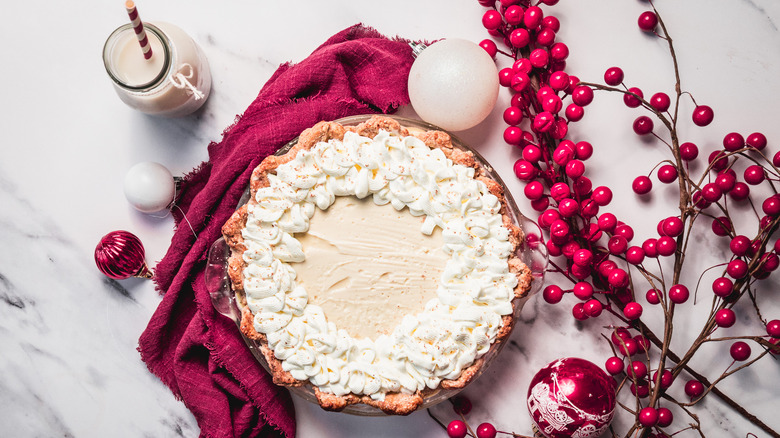 Old-fashioned eggnog pie on marble counter with Christmas decorations