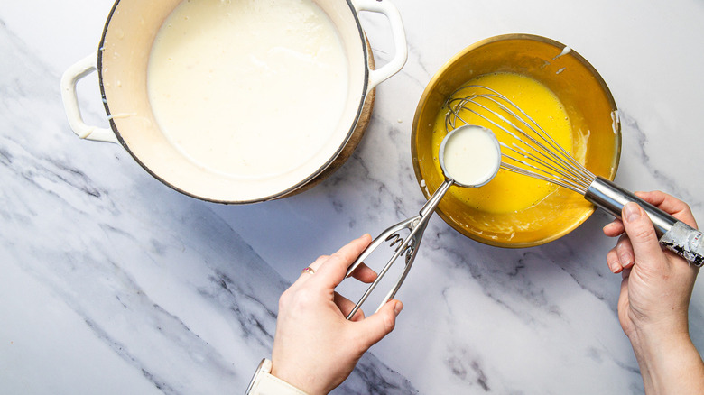 Adding warm custard base to eggs