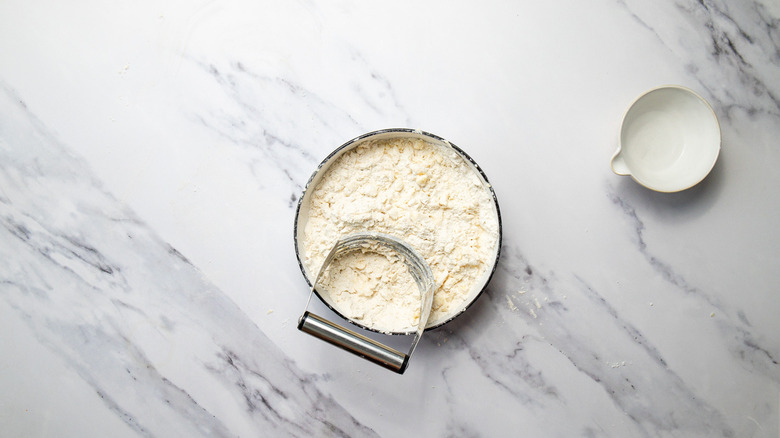 Cutting pie dough in bowl