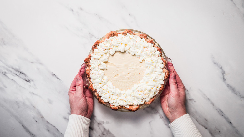 Serving old-fashioned eggnog pie with piping