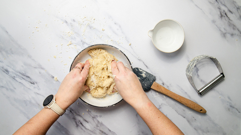 Shaping pie dough in bowl