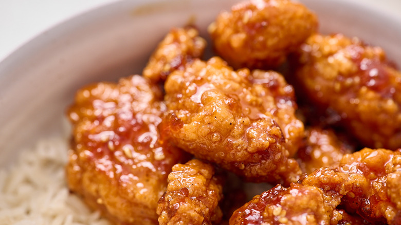 orange chicken in a bowl with rice