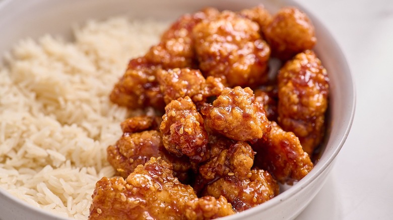 Orange chicken in bowl with white rice