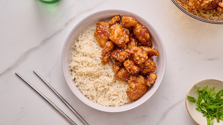 orange chicken in a bowl with rice