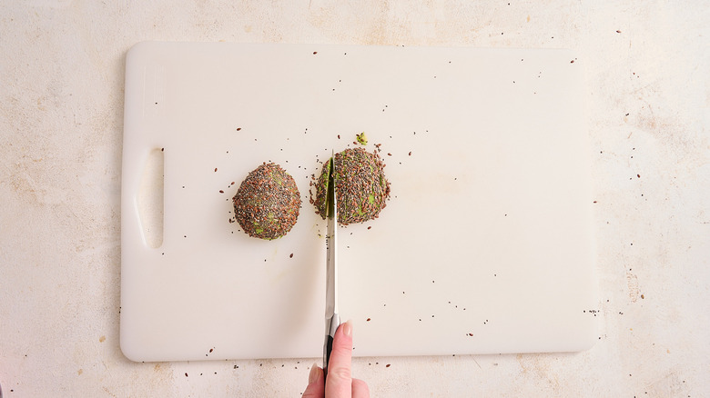 slicing avocado on a cutting board