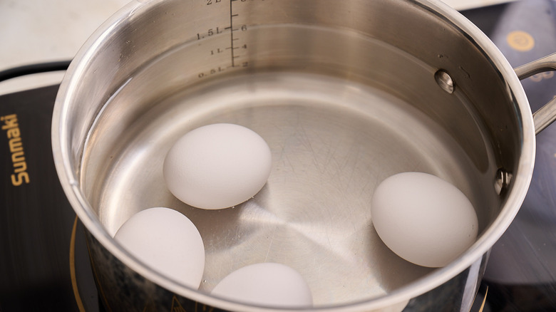 eggs covered with water in a pot