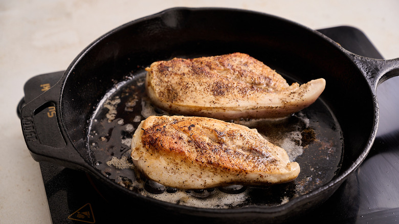 browning chicken breasts in a skillet