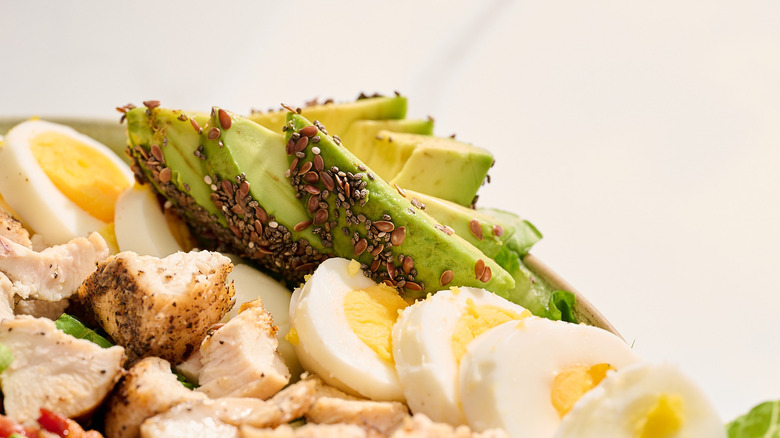 avocado covered in seeds in Cobb salad