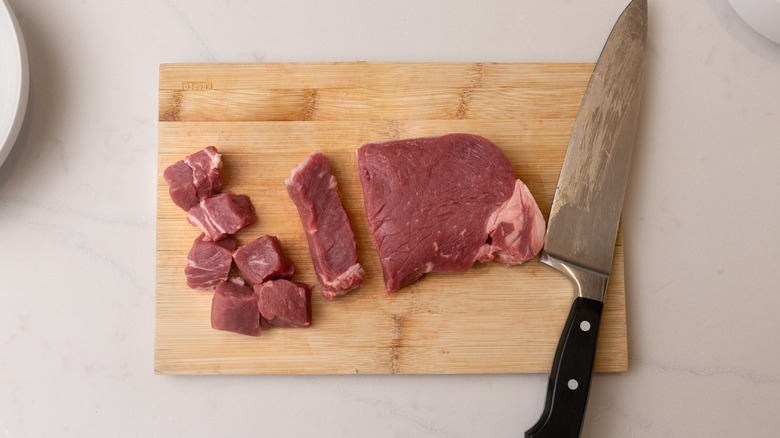 diced steak on chopping board