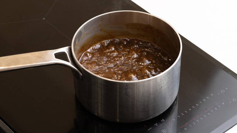 boiling sticky toffee sauce in saucepan