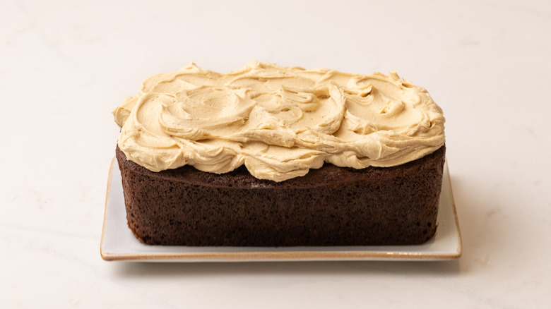 frosted sticky toffee loaf cake on plate
