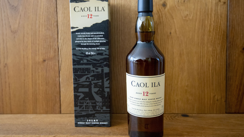 Bottle of Caol Ila 12-Year and its box against a wooden background