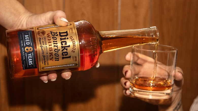 Bottle of George Dickel Bourbon Whisky being poured into a glass