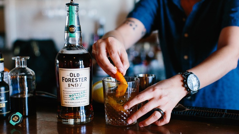 Bottle of Old Forester 1897 Bottled In Bond being used by a bartender for cocktails