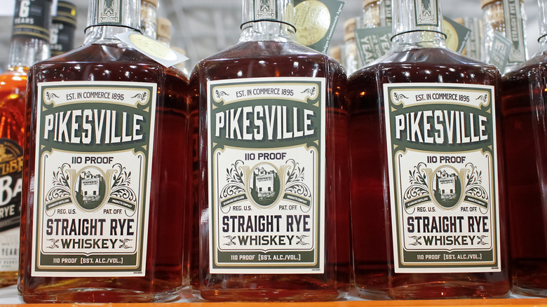 Three bottles of Pikesville Straight Rye Whiskey lined up on a store shelf