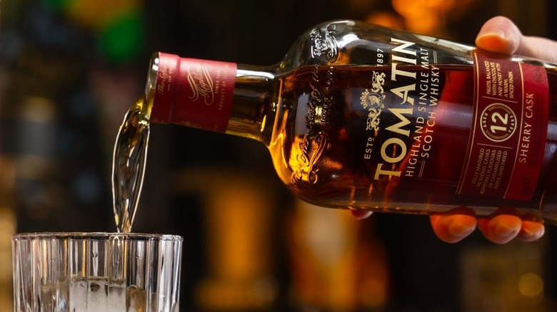 Bottle of Tomatin 12-Year-Old Sherry Cask being poured into a glass