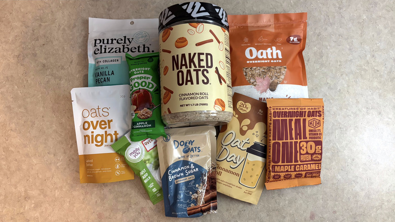Various brands of overnight oat mixes on beige countertop