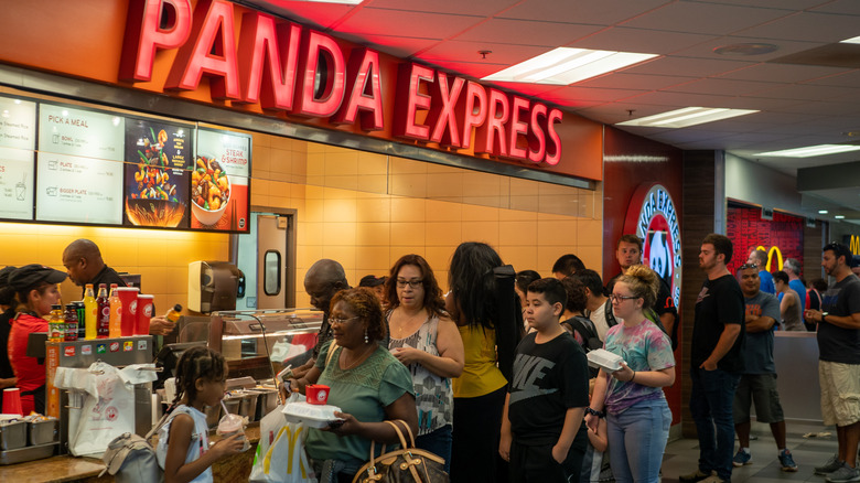Customers waiting in line at a Panda Express counter