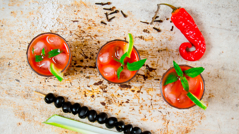 Bloody Mary cocktails surrounded by ingredients