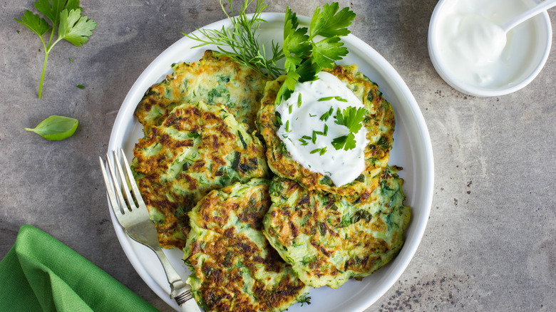 zucchini fritters on a white plate