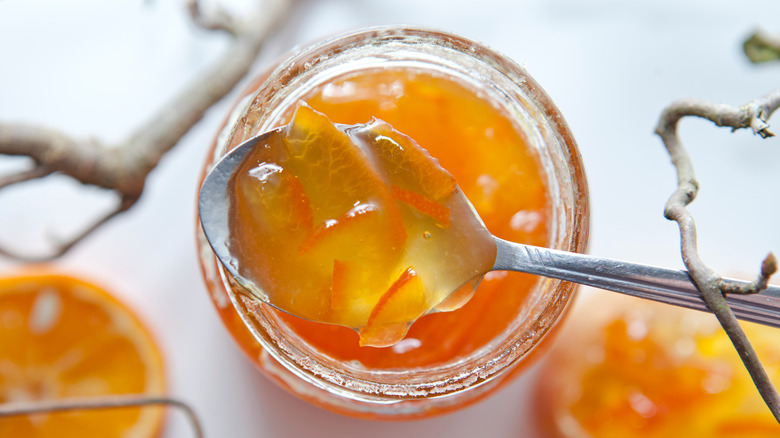 Marmalade in glass jar with spoon