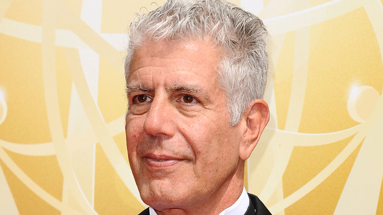 Anthony Bourdain poses at event