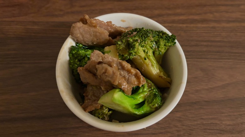 Broccoli and beef in white bowl