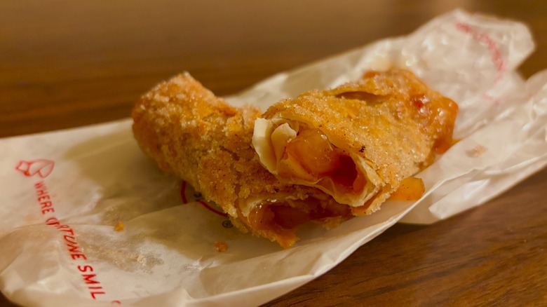 Apple pie roll split in half to show apple pie filling oozing out
