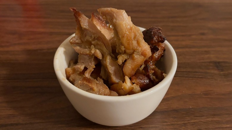 Small white bowl full of chicken